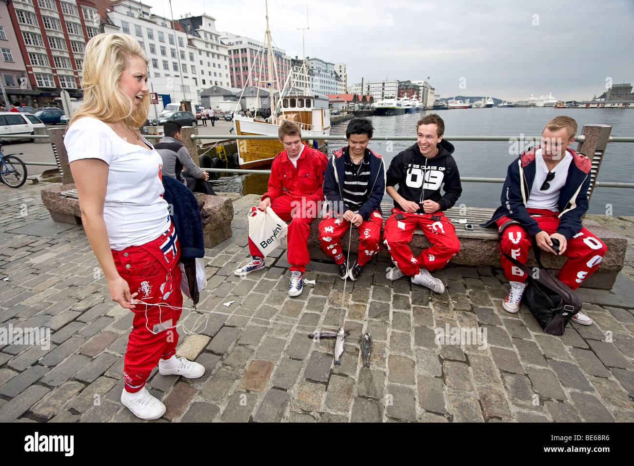 Students in their ceremonial senior graduation pants sit along the  waterfront in Bergen Norway Stock Photo - Alamy