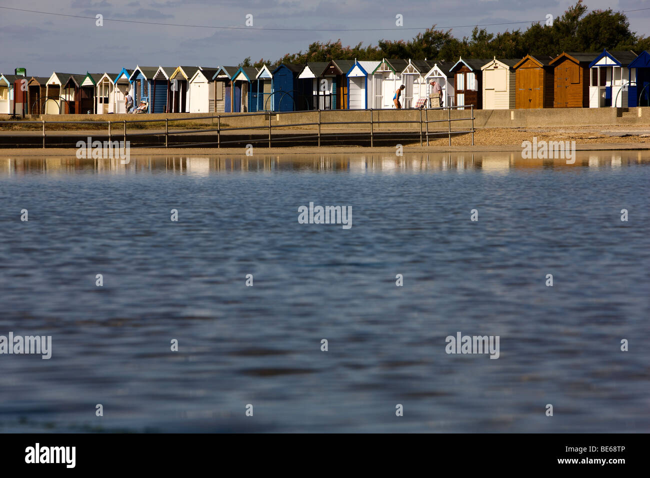 Brightly painted beach huts on the sea front of  the Essex coastal town of Brightlingsea are the star attraction of resort Stock Photo