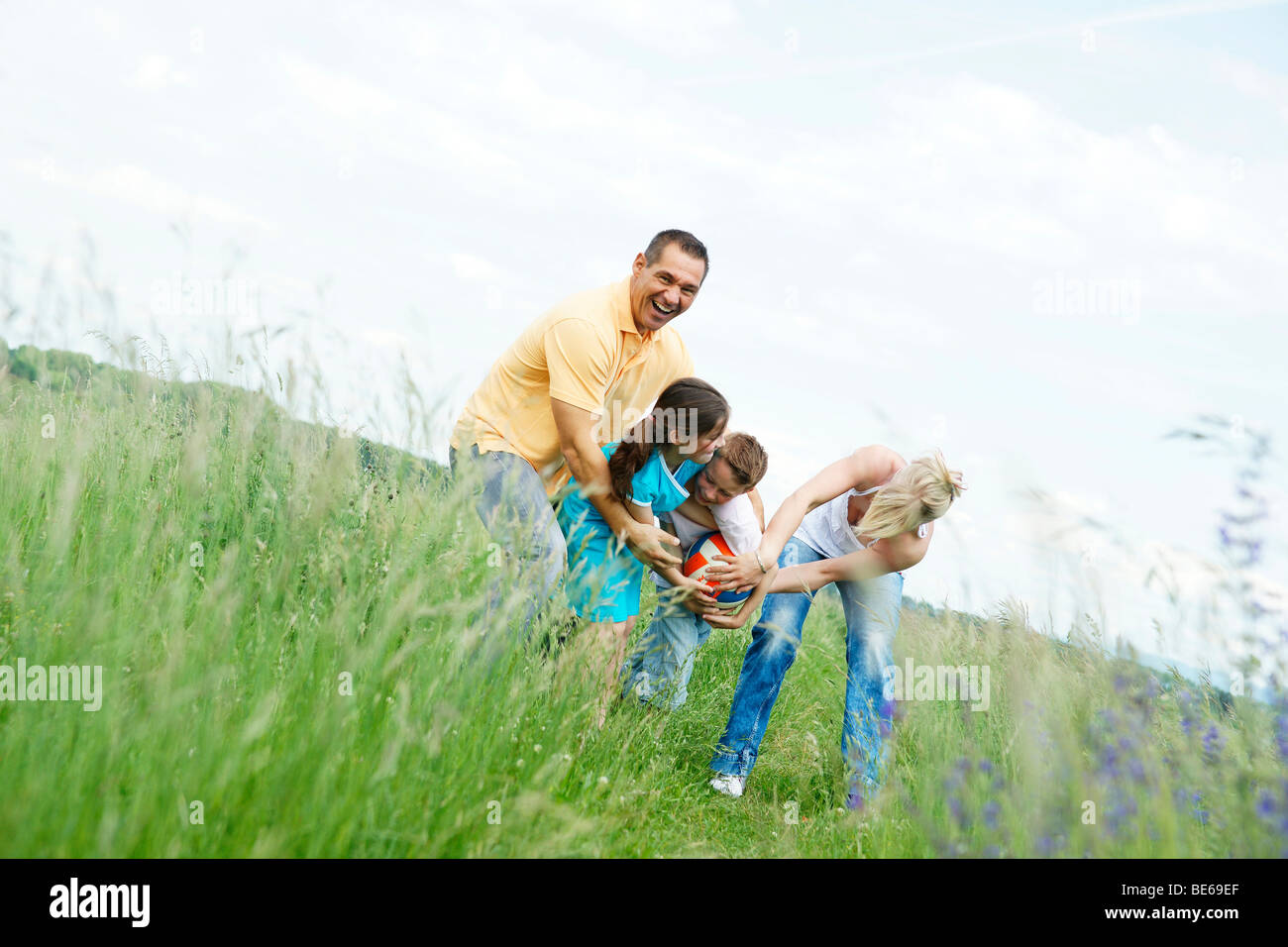 Family playing on a meadow Stock Photo