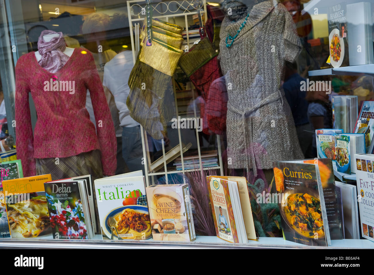 Display of cookery books and clothes for sale in charity shop during Abergavenny Food Festival Monmouthshire South Wales UK Stock Photo