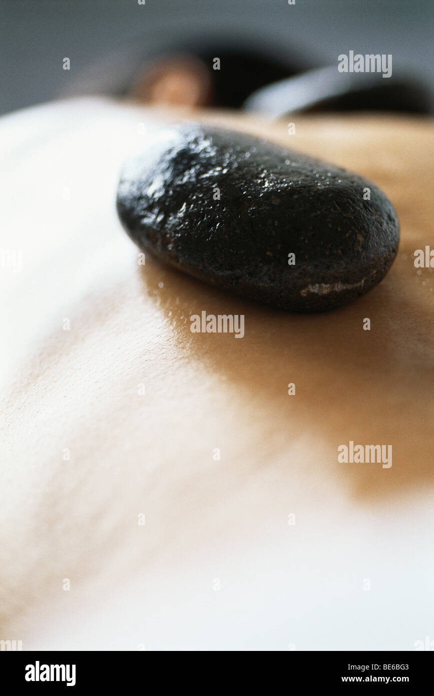 Lastone therapy, stone placed on patient's bare back Stock Photo