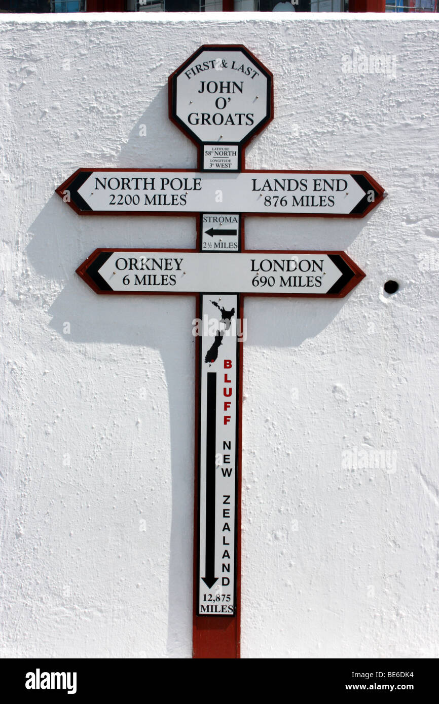 direction sign and distance markers on a wall at John O'Groats, the most north-easterly settlement on the UK Mainland Stock Photo