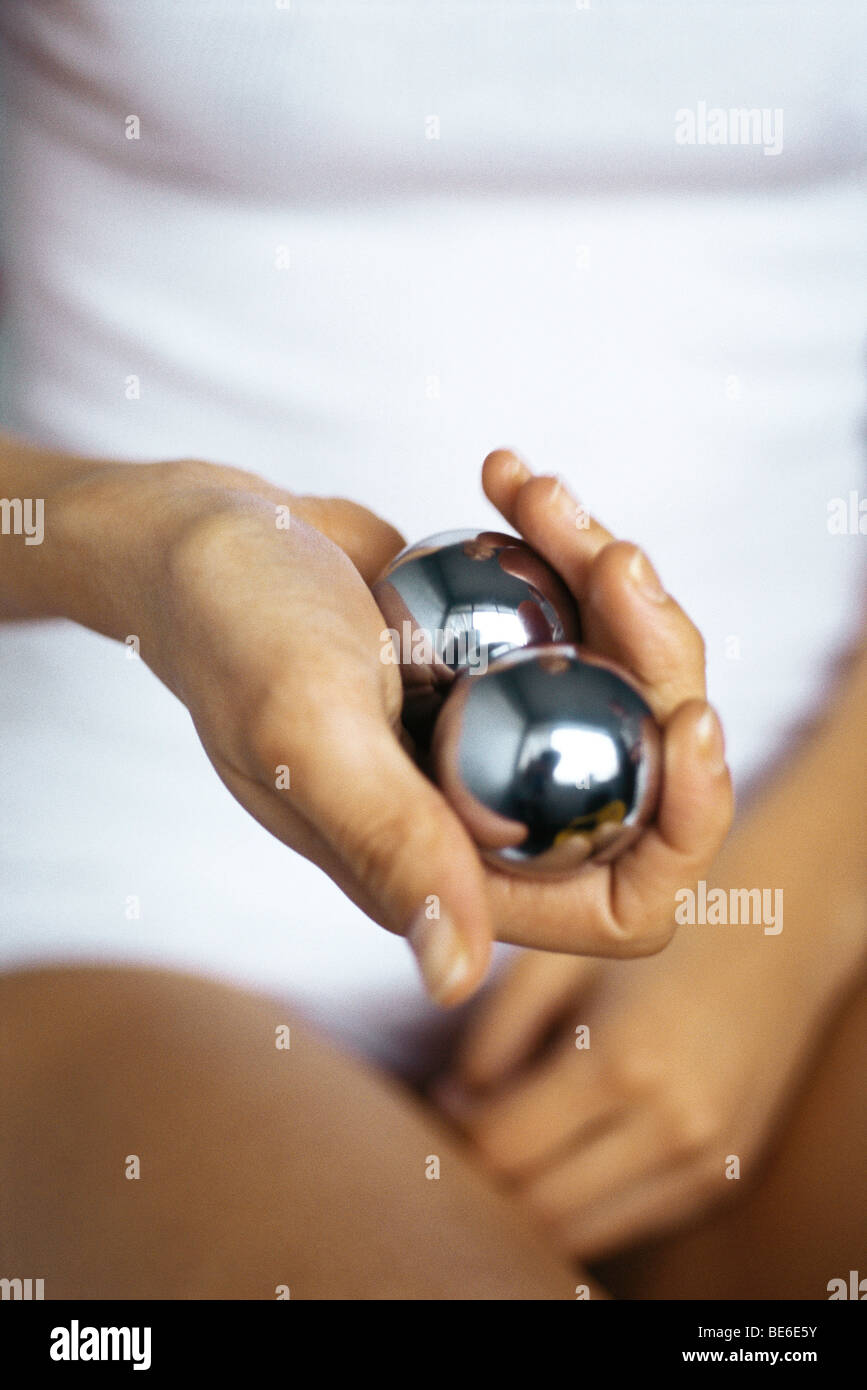 Woman holding yin yang balls, cropped Stock Photo