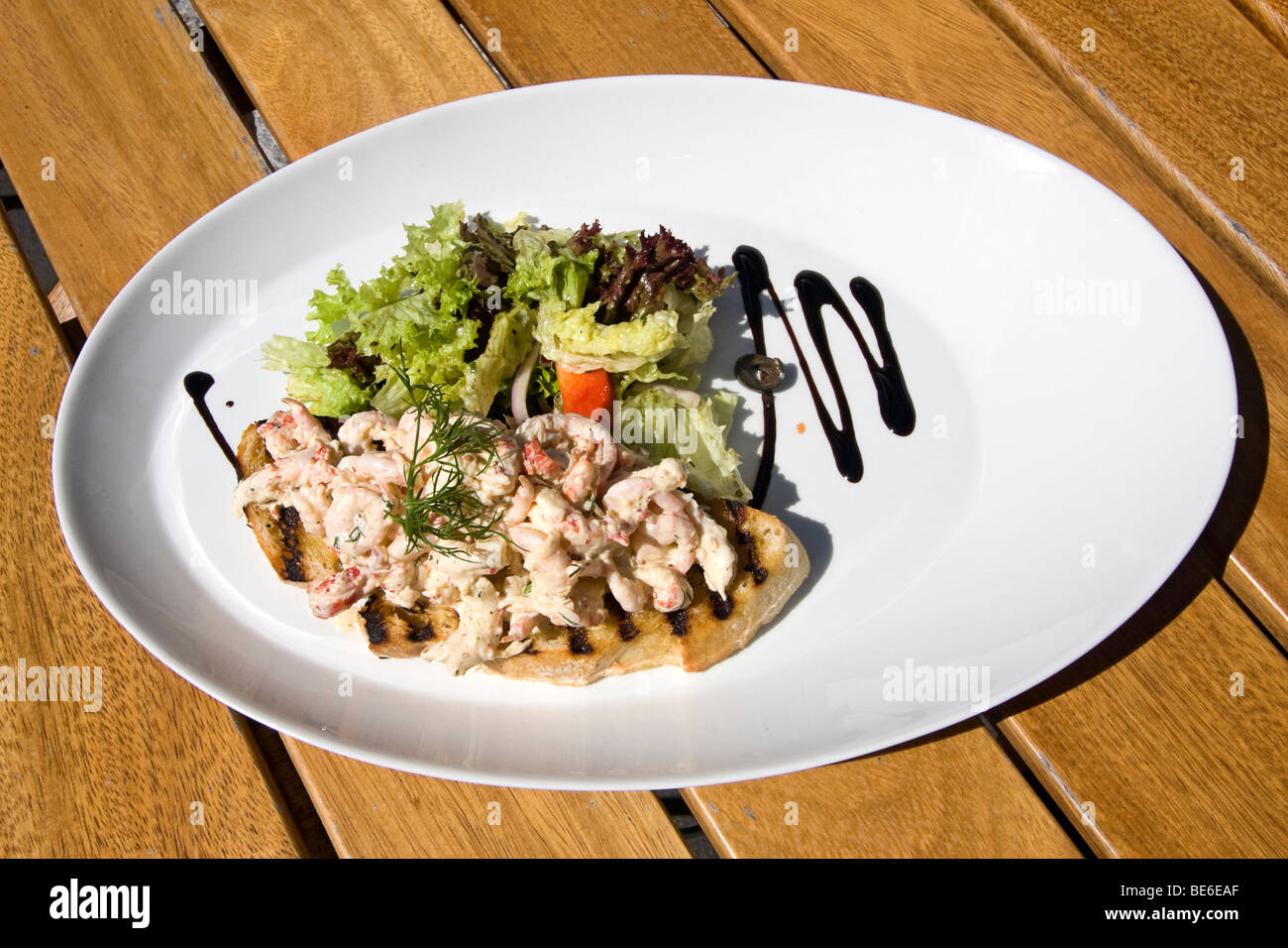 Typical open faced Norwegian sandwich featuring shrimp salad and greens