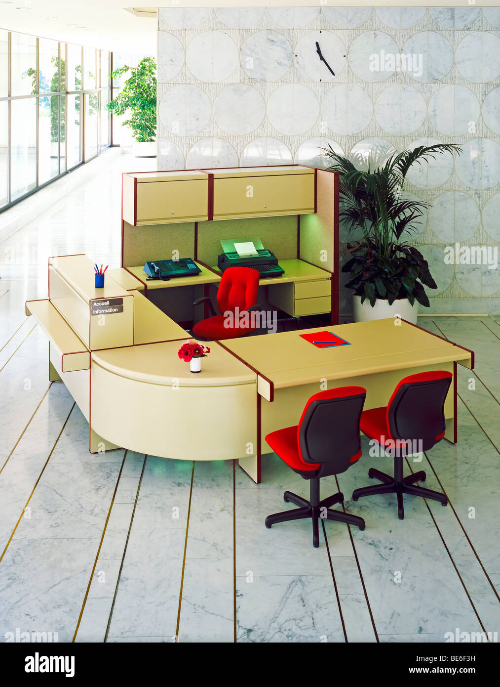 1980s office reception desk with red chairs Stock Photo