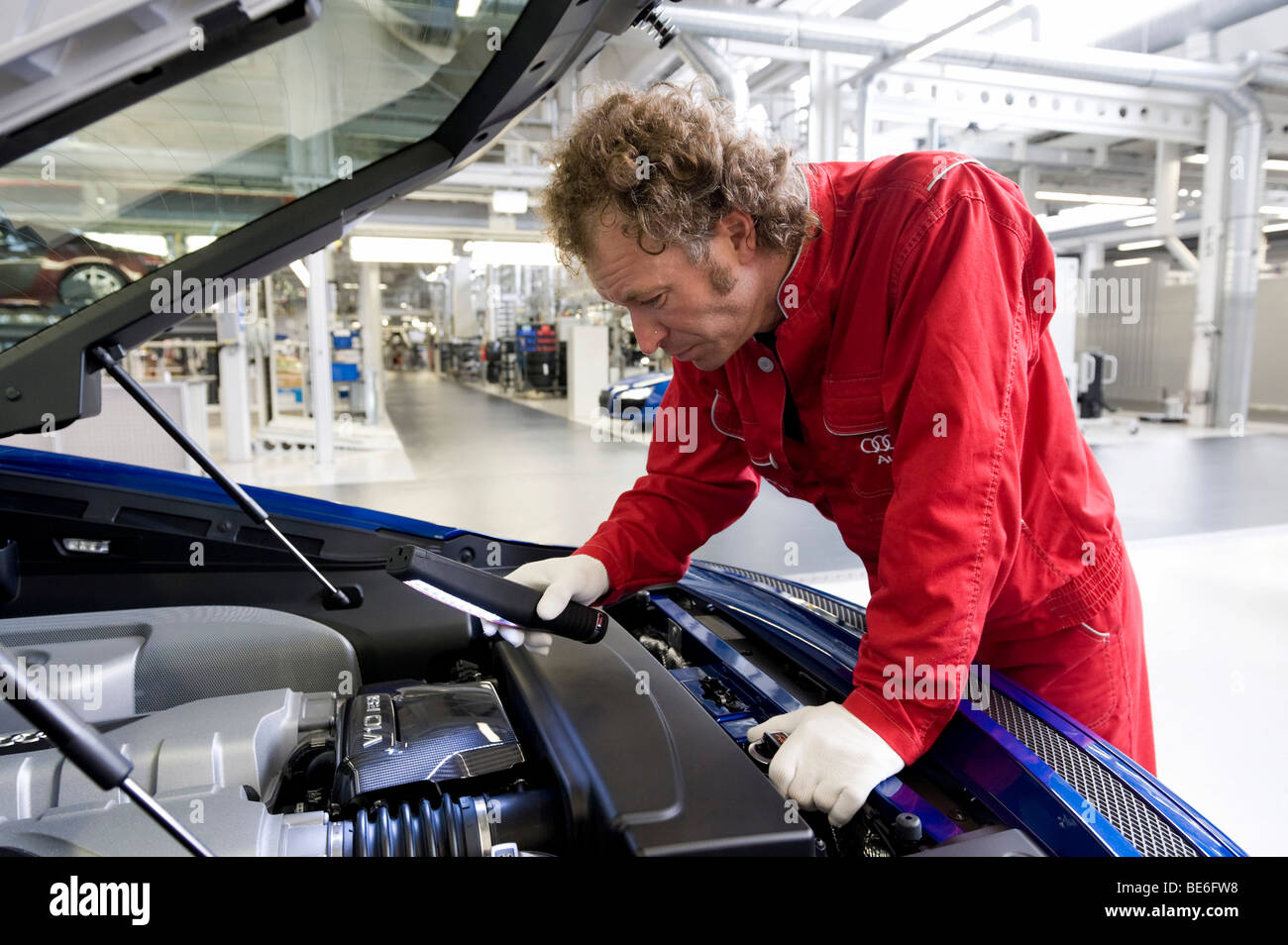 Audi employee doing final inspections of the Audi R8 sports car at the