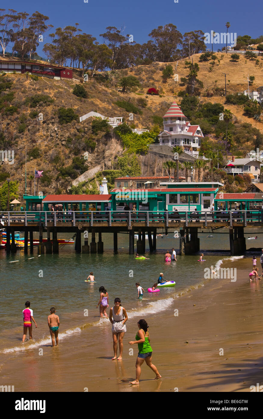 AVALON, CA, USA People on beach near Pleasure Pier in Avalon Bay