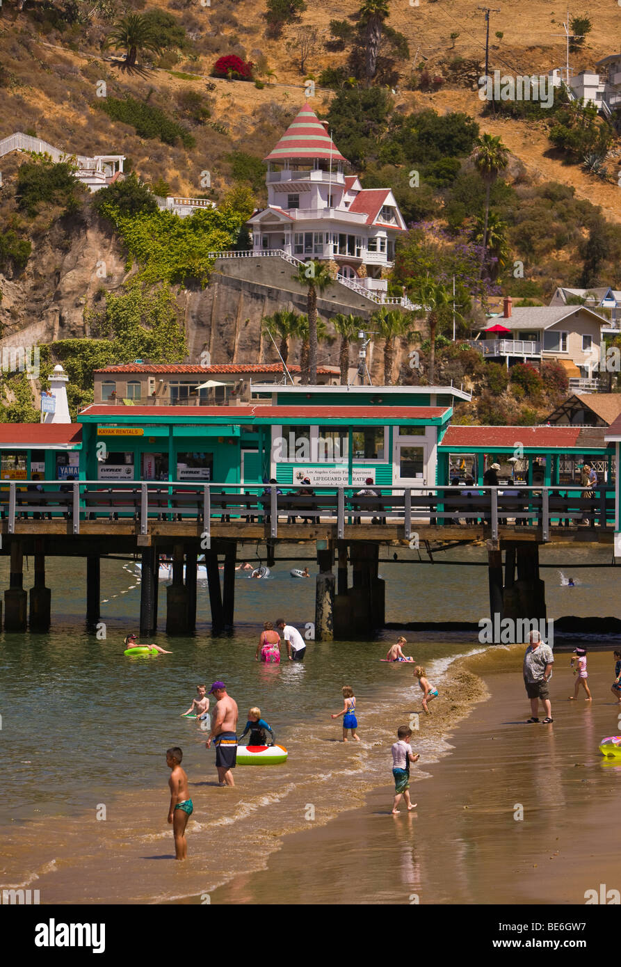 AVALON, CA, USA People on beach near Pleasure Pier in Avalon Bay