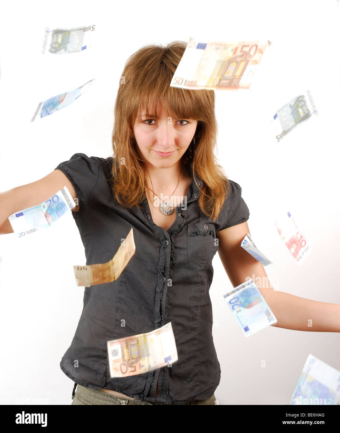 Young woman in a shower of money Stock Photo