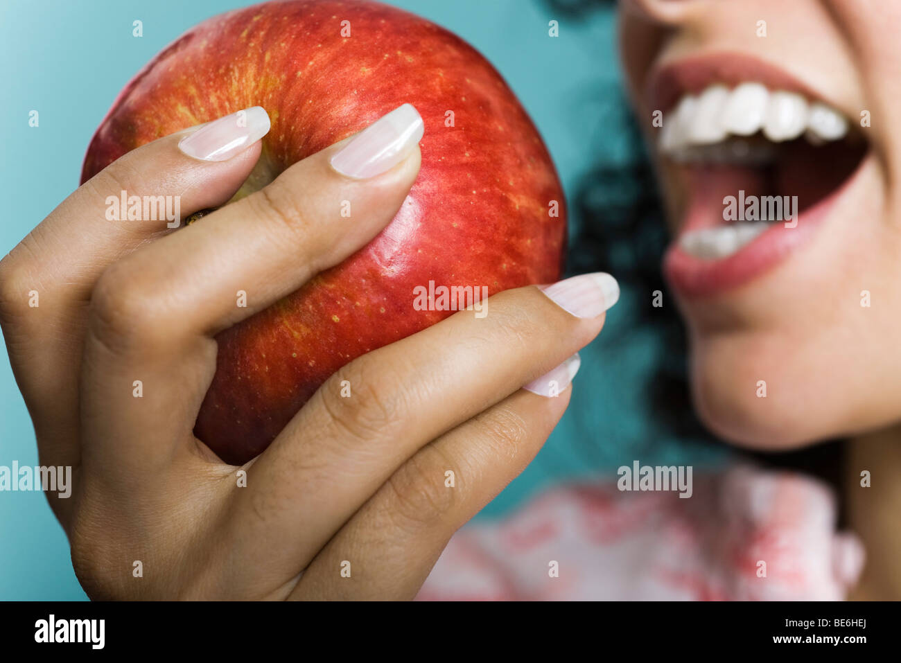 Woman eating apple, close-up Stock Photo