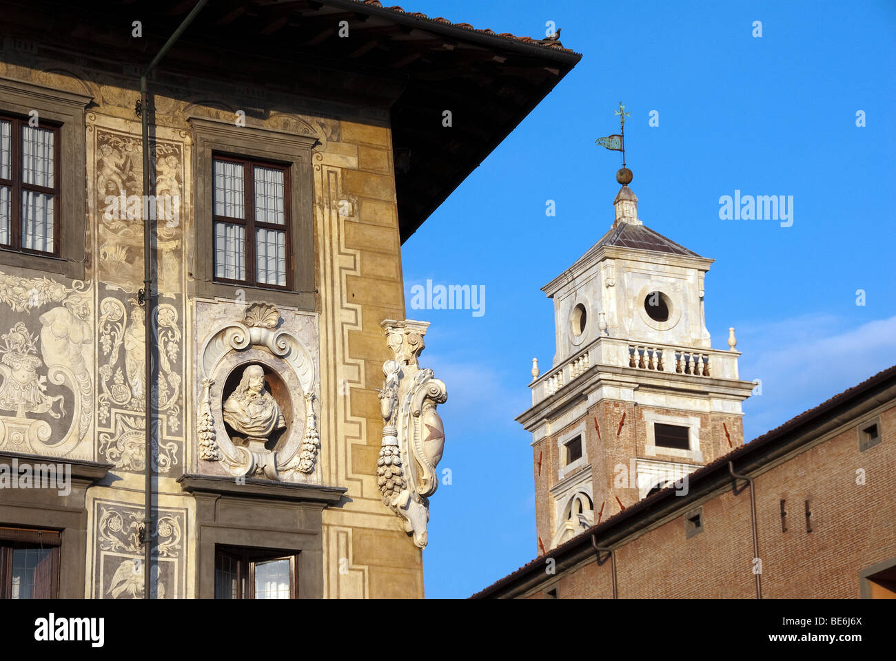 Decorated Facade of the Scuola Normale Superiore, Pisa with bust of one of the Grande Dukes of Tuscany and belltower Stock Photo
