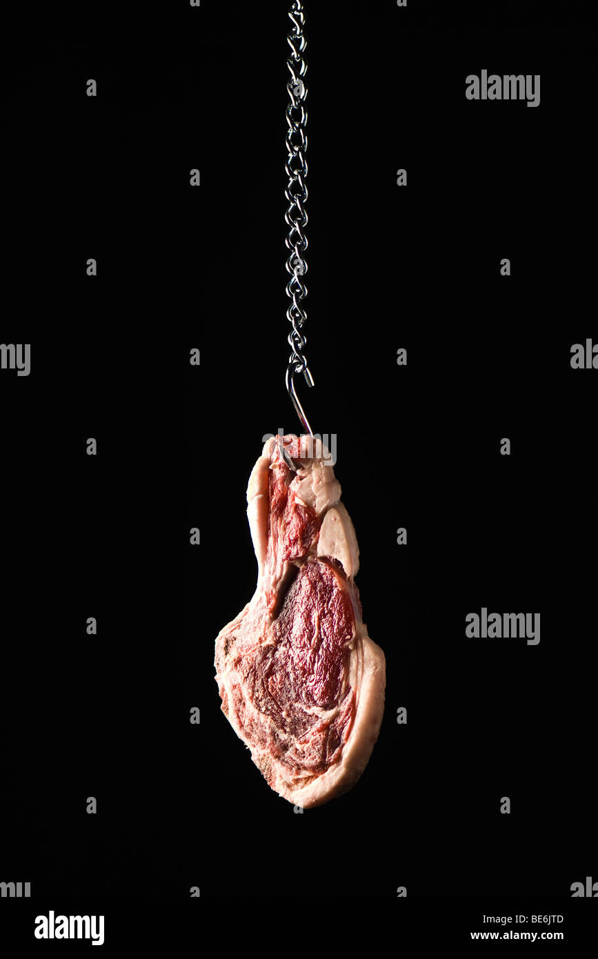 Steak hanging from meat hook Stock Photo