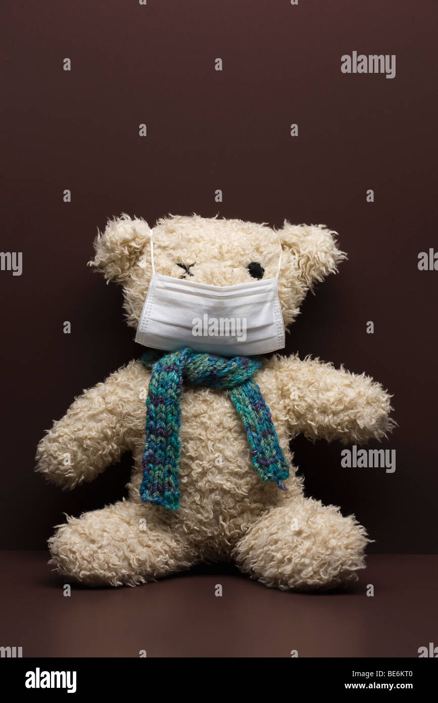 Teddy bear wearing flu mask Stock Photo
