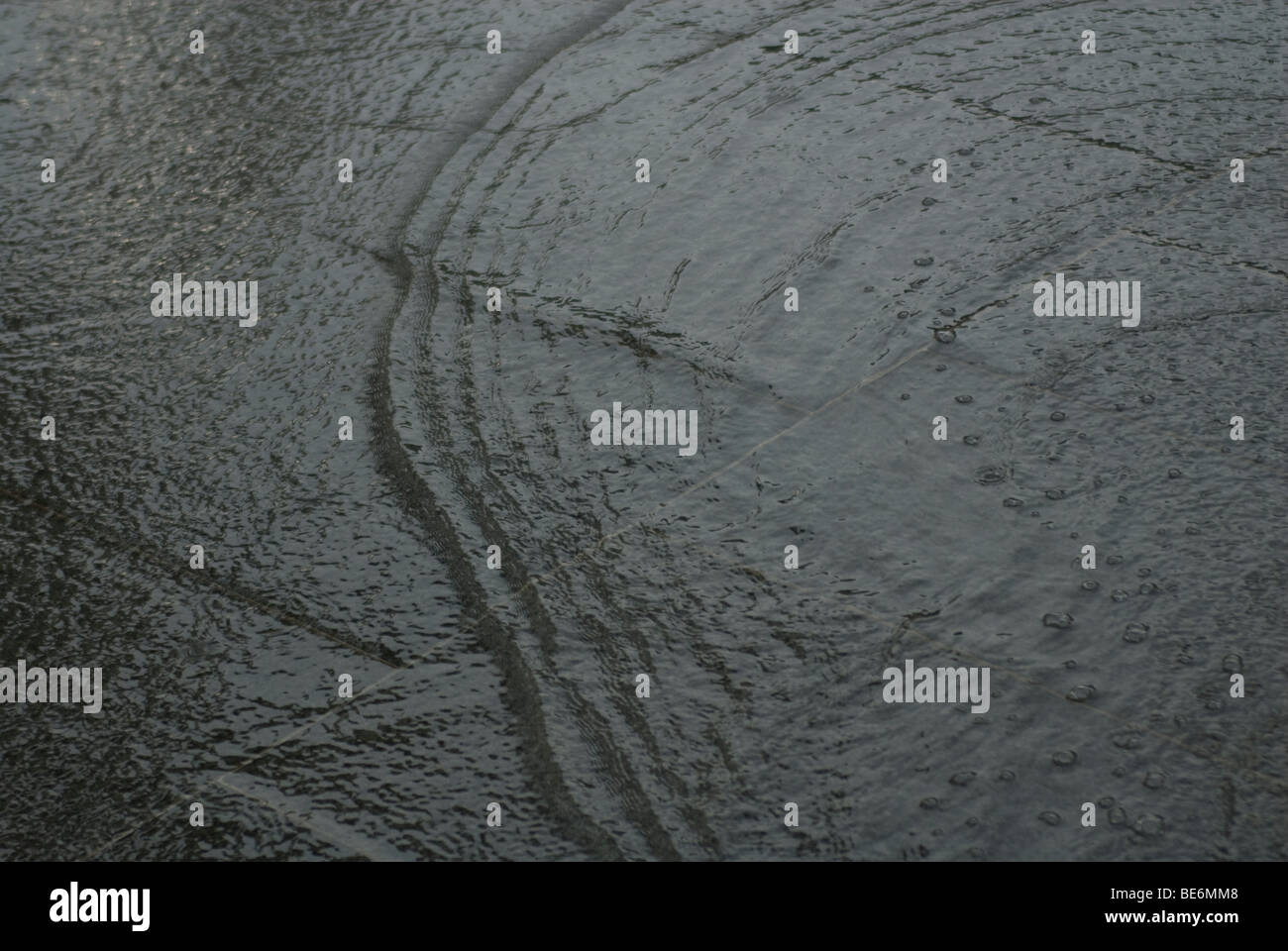 wave of water rippling across the pavement Stock Photo - Alamy