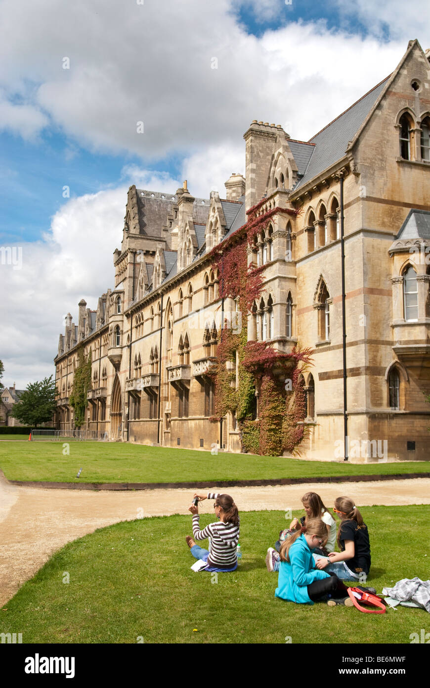 A group of young girls sitting on the lawn outside Christ College, St Aldate's on the Broadwalk Stock Photo