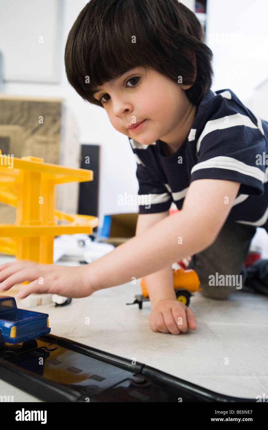 Little boy playing with toy cars, close-up Stock Photo - Alamy