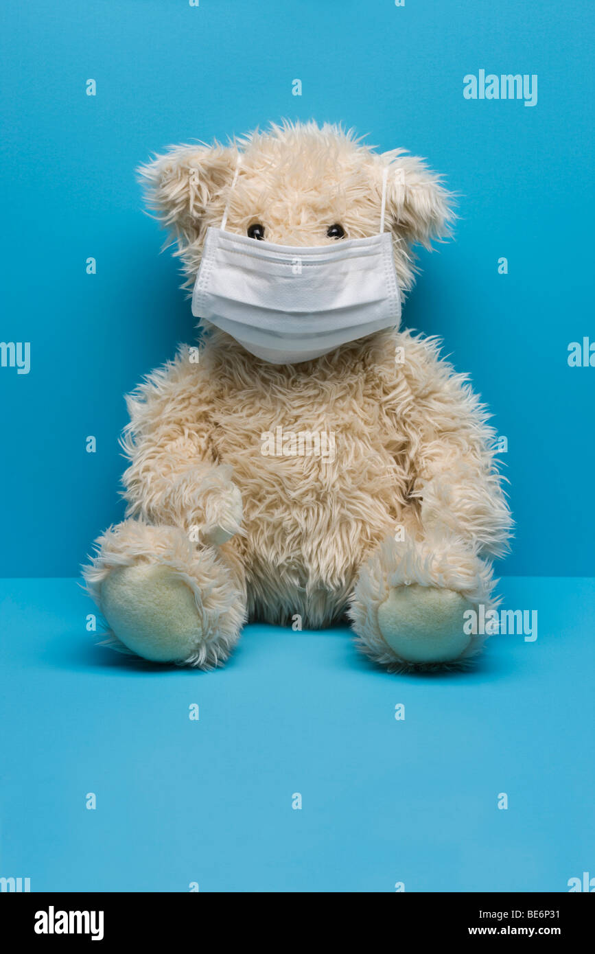 Teddy bear wearing flu mask Stock Photo