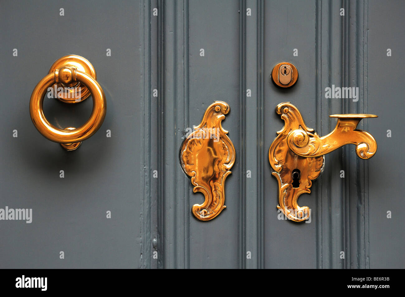 Old door knocker and old brass door handle, Lueneburg, Lower Saxony, Germany, Europe Stock Photo