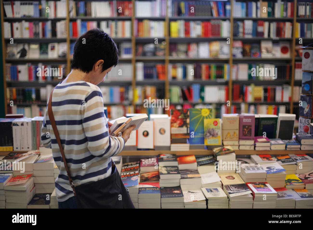 woman reading in books in a bookstore Stock Photo