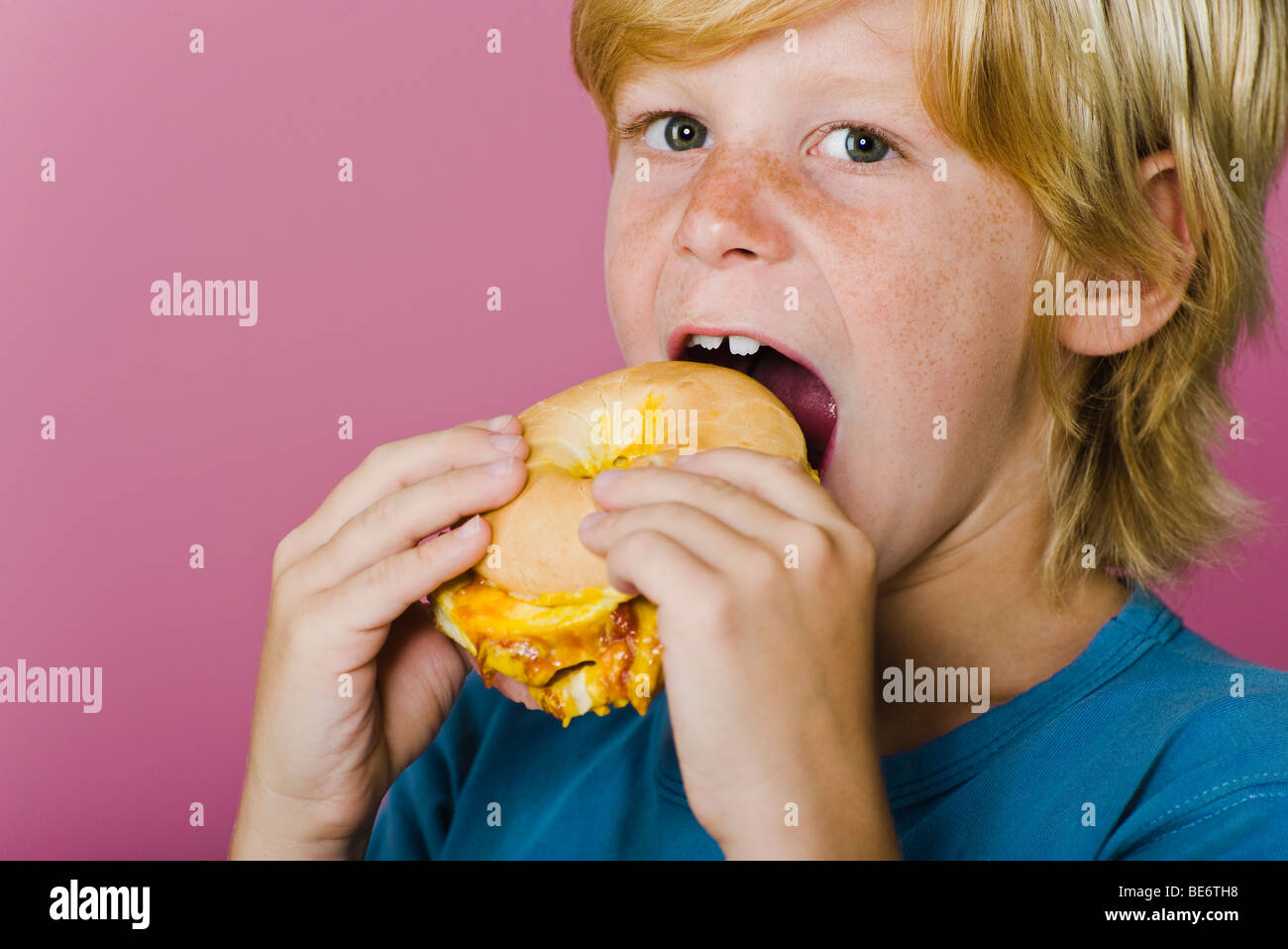 Boy eating ham and cheese sandwich Stock Photo Alamy