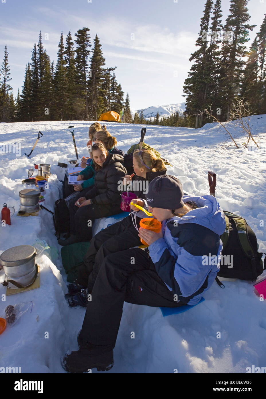 Group of children practising cooking skills for winter camping, Yukon outdoor school program, White Pass, Chilkoot Pass, Chilko Stock Photo