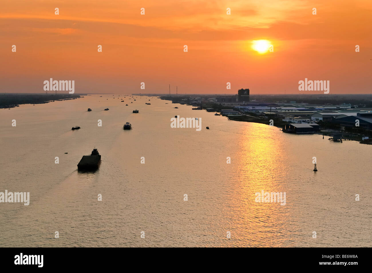 Transport boats in the last evening light during sunset on the Mekong River, My Tho, Mekong Delta, Vietnam, Asia Stock Photo
