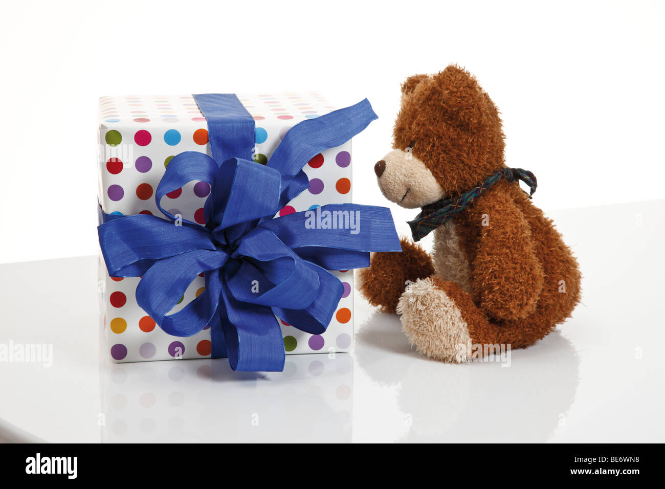 Present with a ribbon and a teddy bear Stock Photo