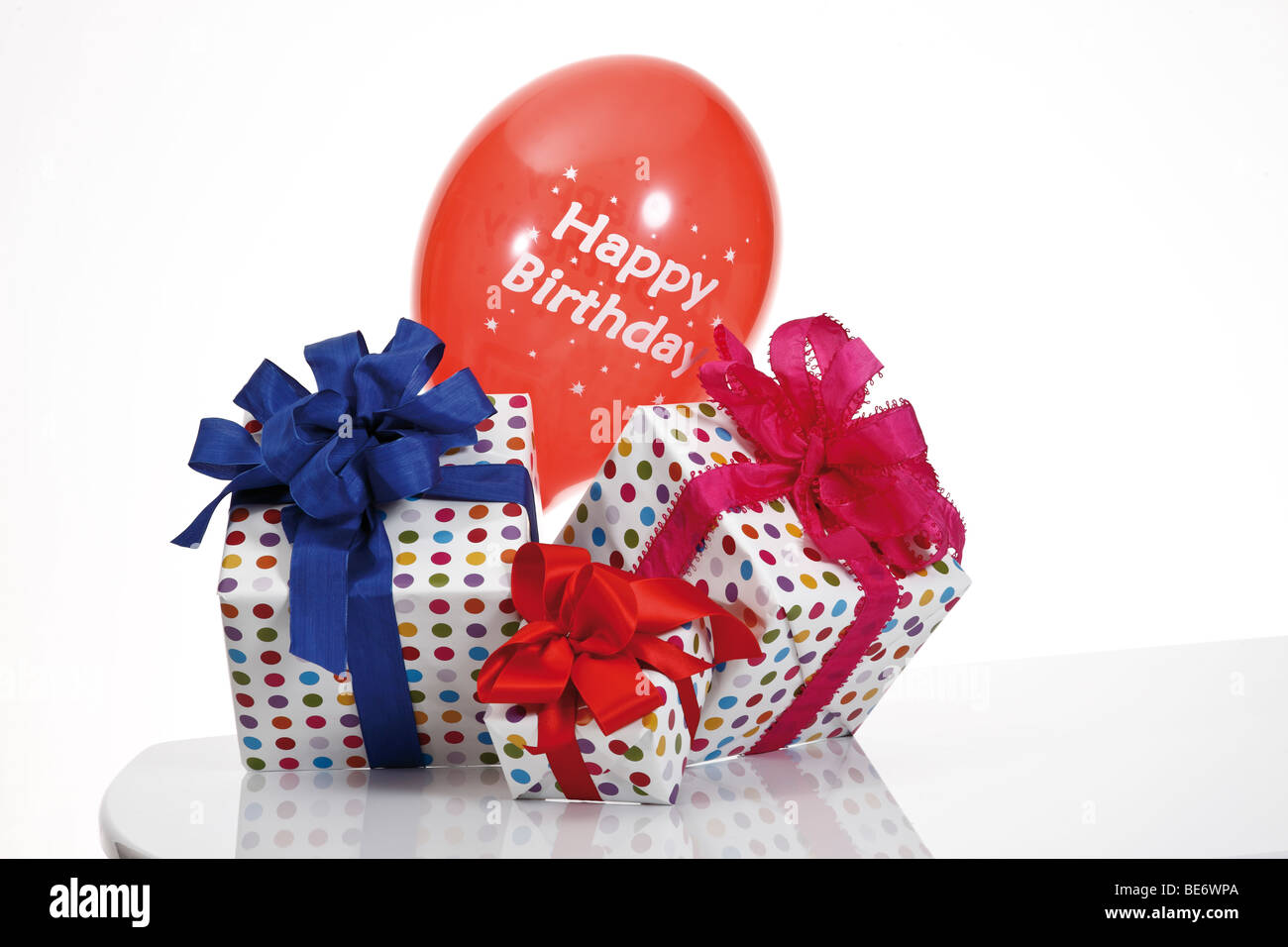 Presents with ribbons and a balloon, Happy Birthday Stock Photo