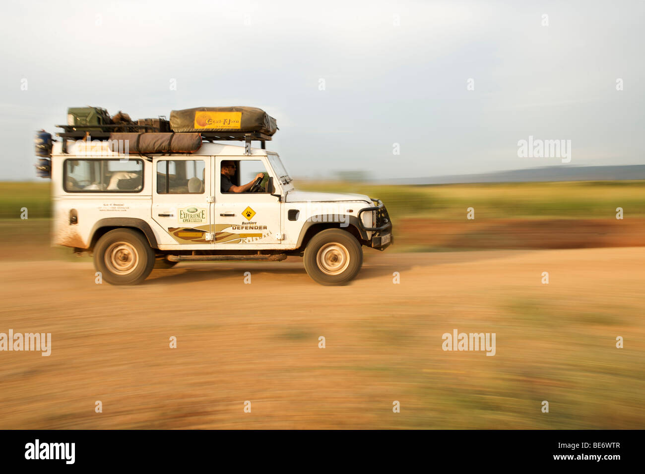 Land Rover Defender driving through the Kabwoya Wildlife Reserve in