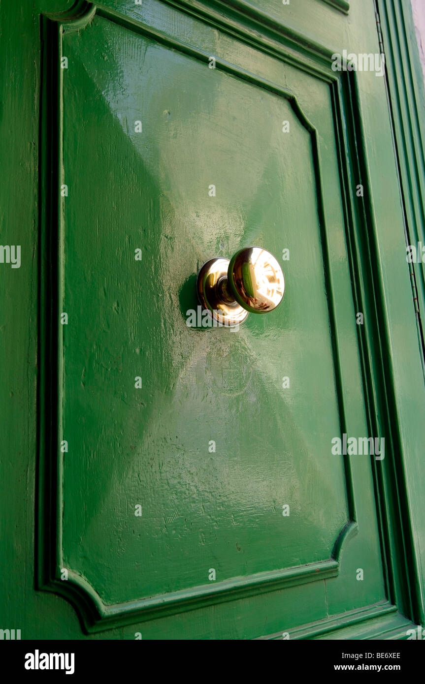 Green door with brass handle. Stock Photo