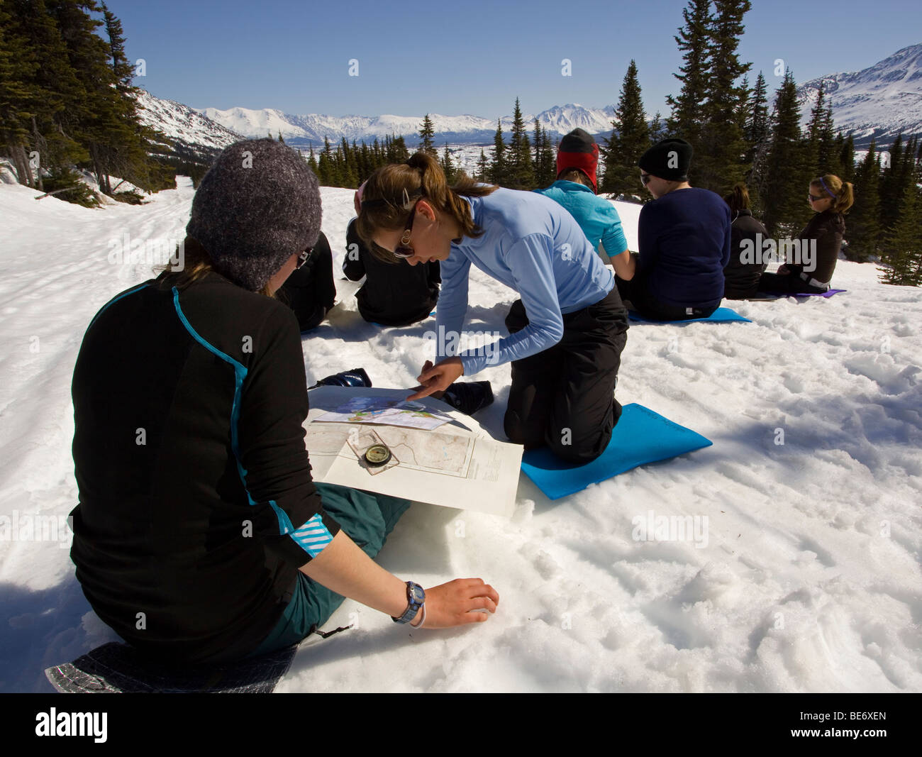 Group of young girls practising navigation with map and compass, Yukon outdoor school program, White Pass, Chilkoot Pass, Chilk Stock Photo