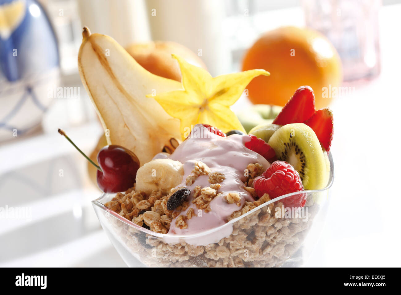 Fruit muesli, raspberries, strawberries, kiwi, pear, banana, cherry