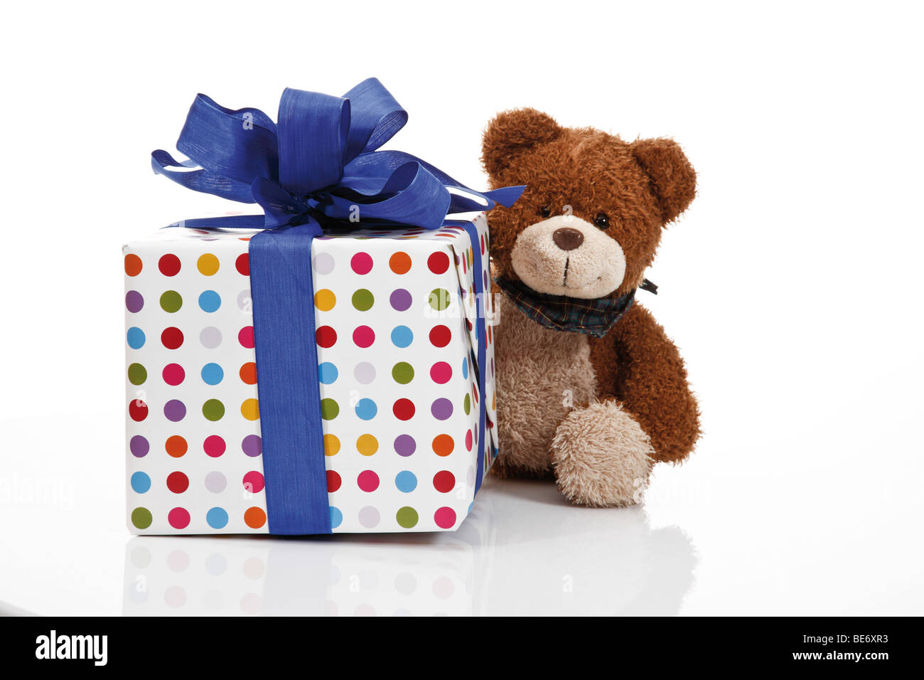 Present with a ribbon and a teddy bear Stock Photo