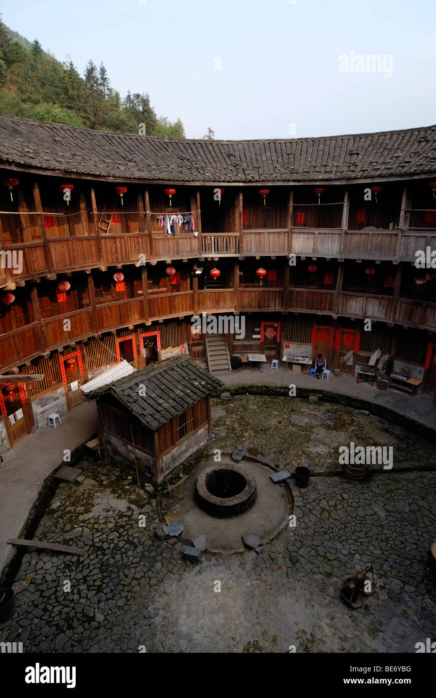 Courtyard with a fountain of a Tulou round house, dirt round houses, adobe round houses, the Chinese minority Hakka, near Yongd Stock Photo