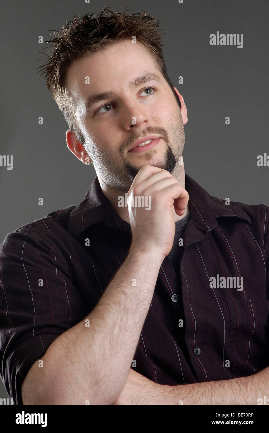 Close-up view of man considering or thinking about something. Stock Photo
