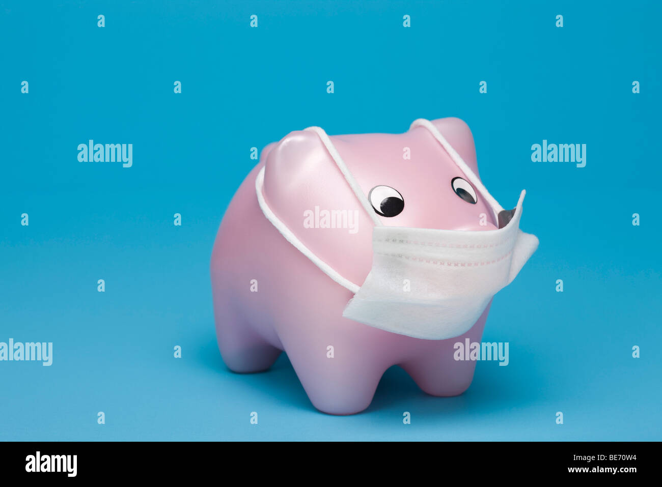 Swine flu concept, toy pig wearing flu mask Stock Photo