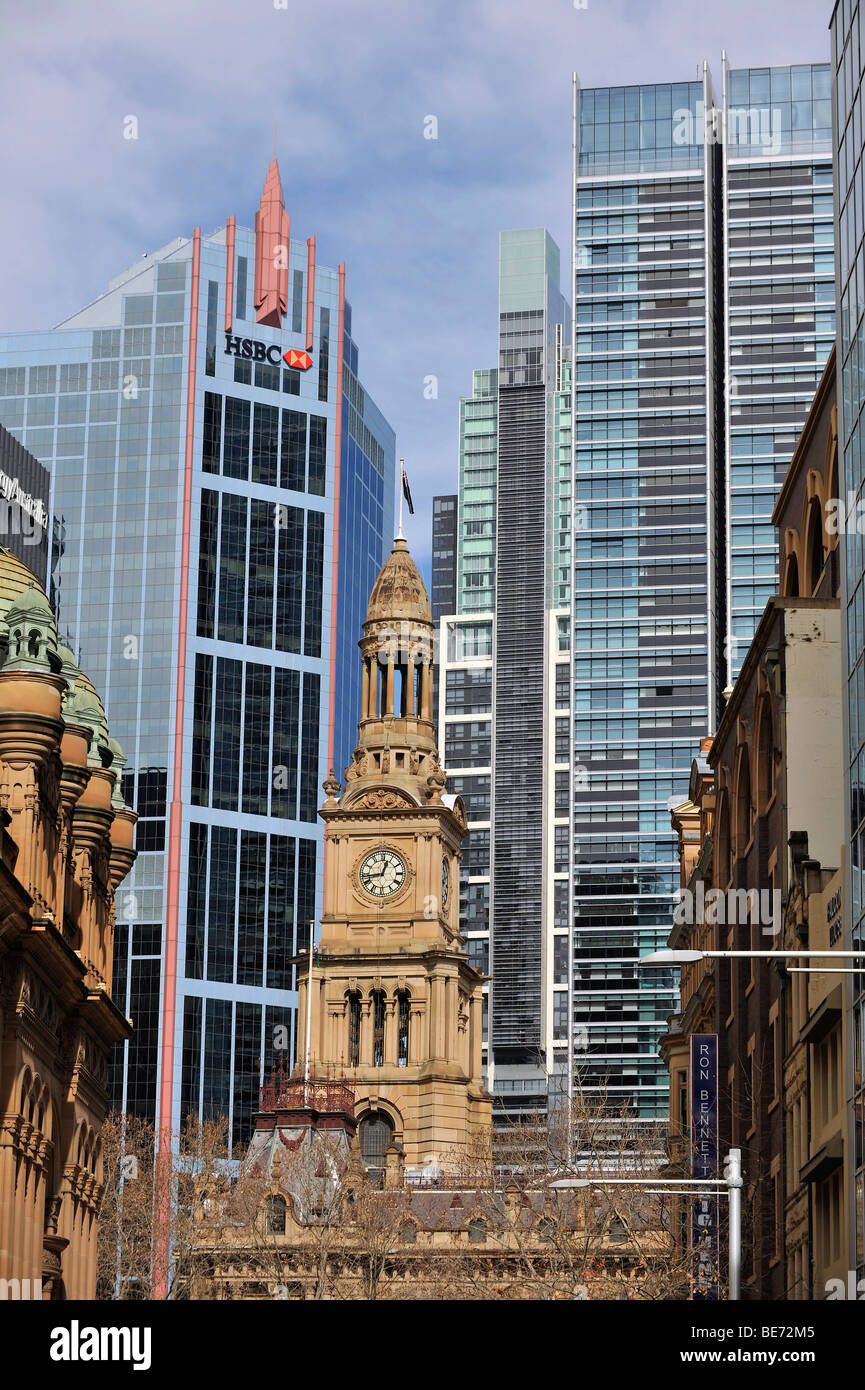 West side tower of the Sydney Town Hall, a Victorian building, in front of skyscrapers, Sydney, New South Wales, Australia Stock Photo