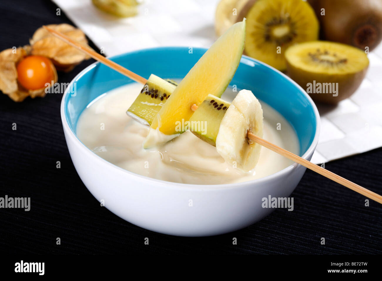 Vanilla yogurt with fruits on a skewer Stock Photo