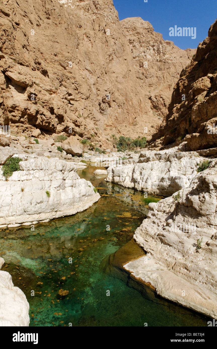 Clear blue water in the canyon of Wadi Shab, Hajar ash Sharqi Mountains, Sharqiya Region, Sultanate of Oman, Arabia, Middle East Stock Photo