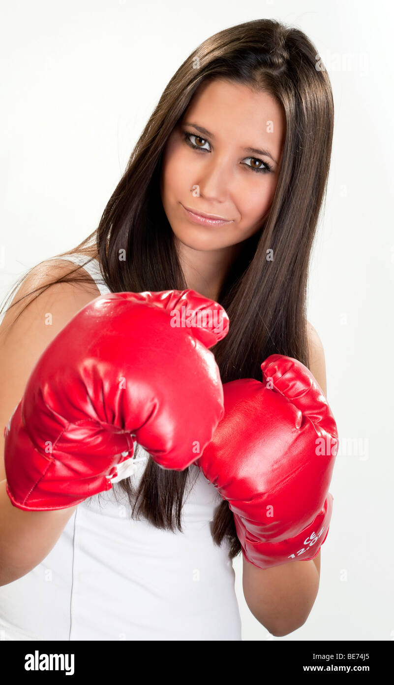 Young woman, 20, wearing boxing gloves Stock Photo