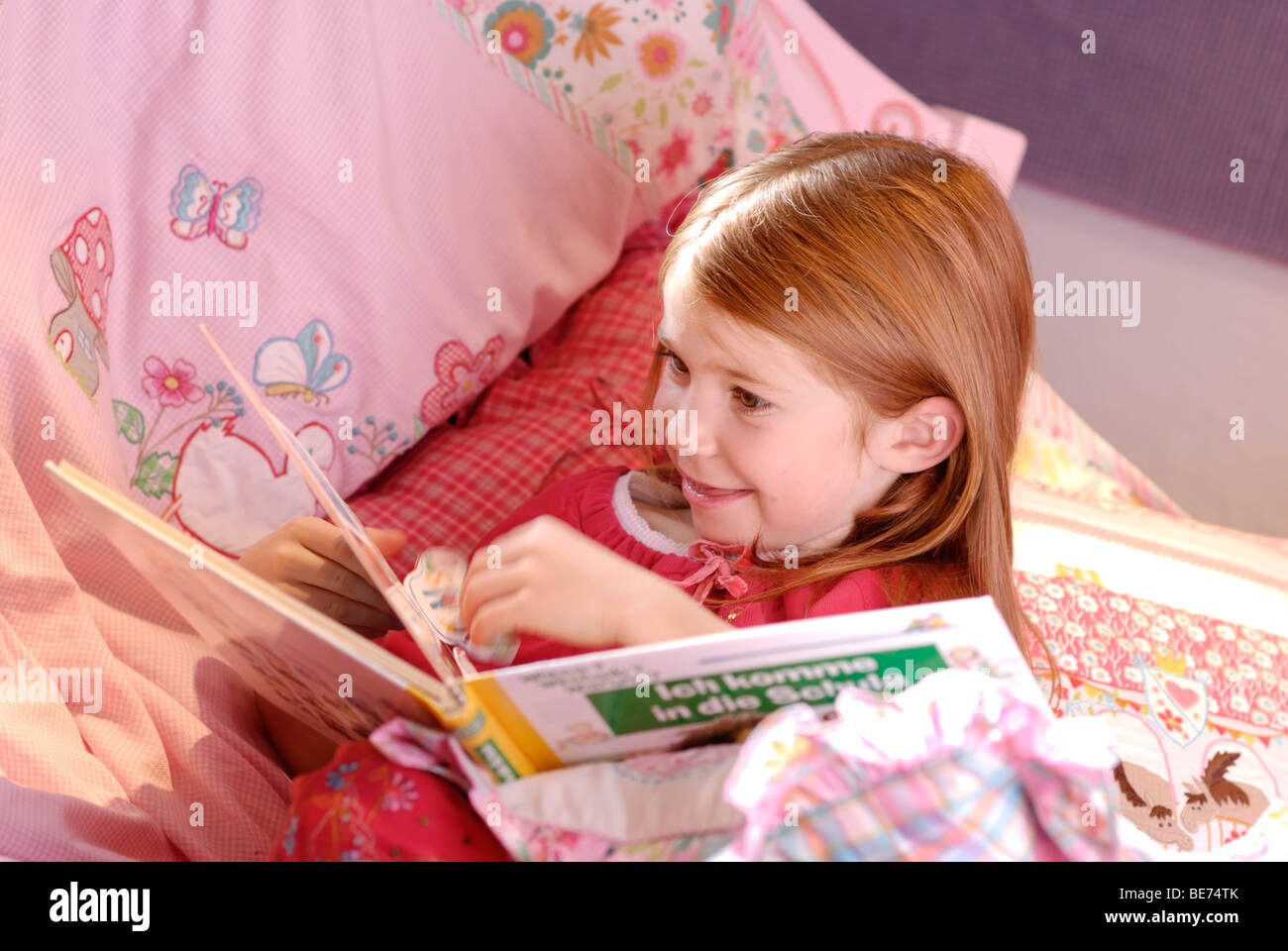 Little girl reading a picture book Stock Photo