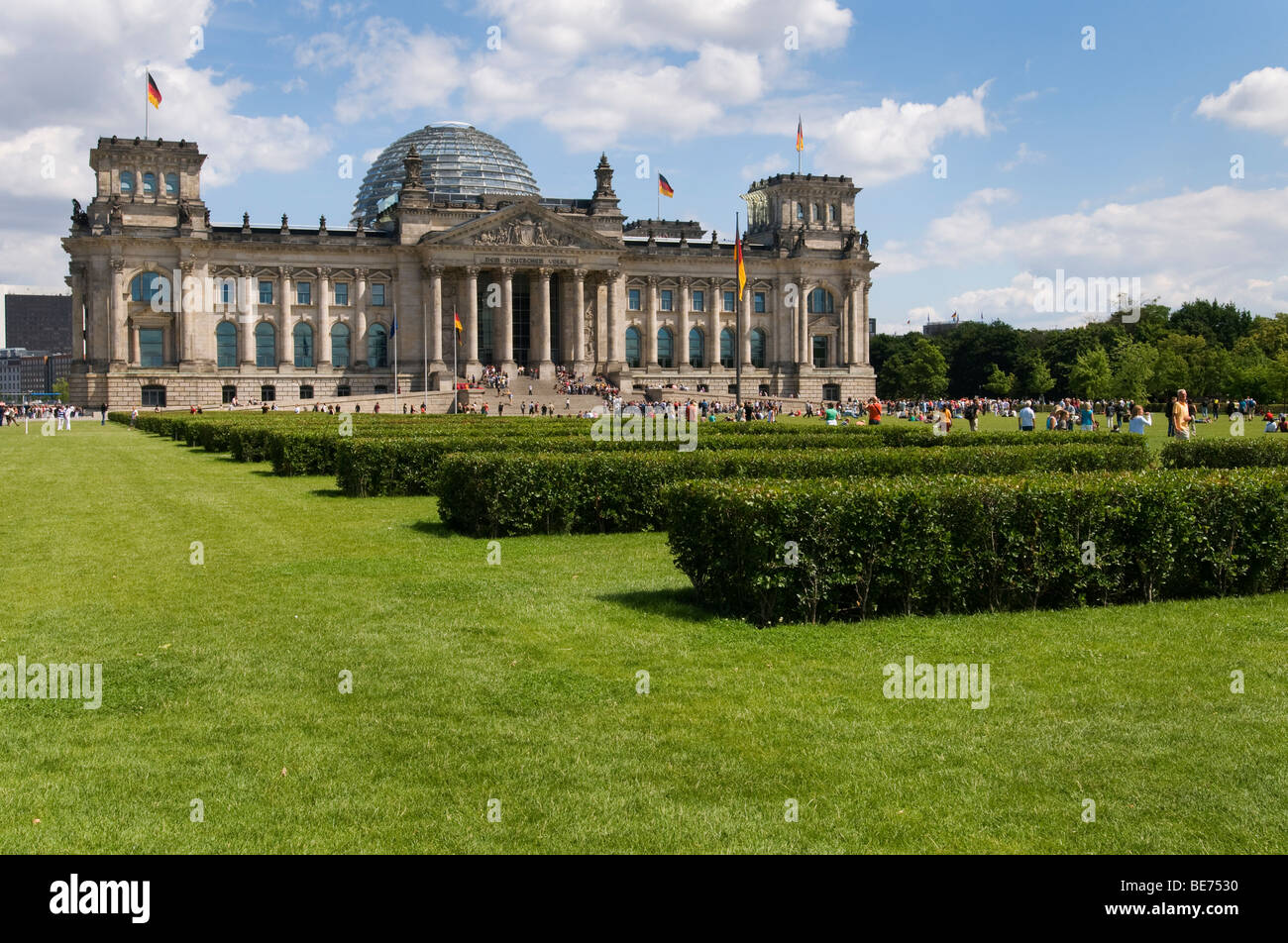 People relaxing on the lawn in front of  the German Parliament building, the Reichstag on a summer's day. Stock Photo