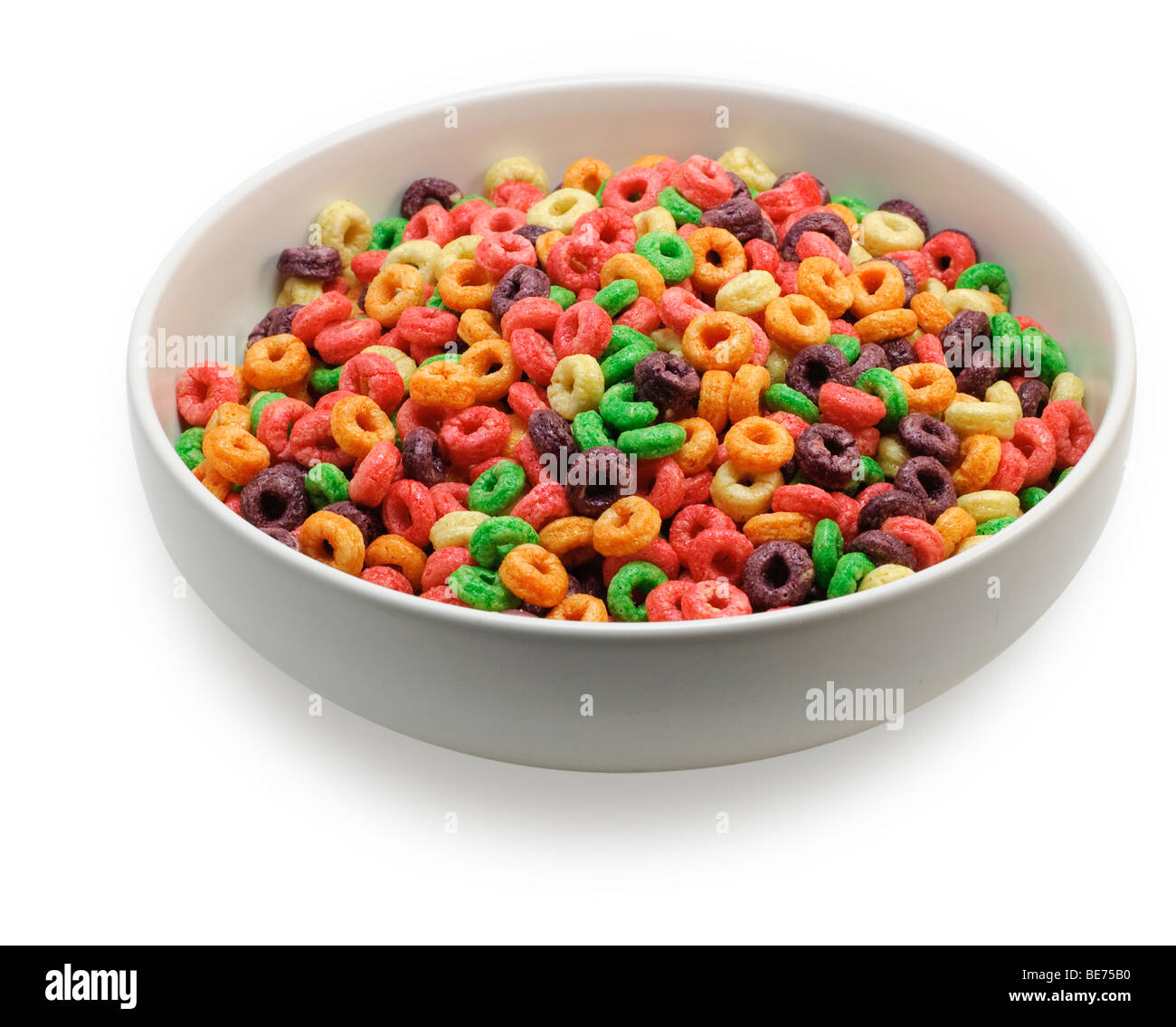 Bowl with colorful round cereal, seen from an angle, isolated on white background. Saved with clipping path Stock Photo