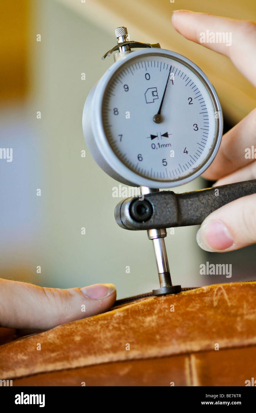 Measuring the thickness of the leather using a dial gauge Stock Photo