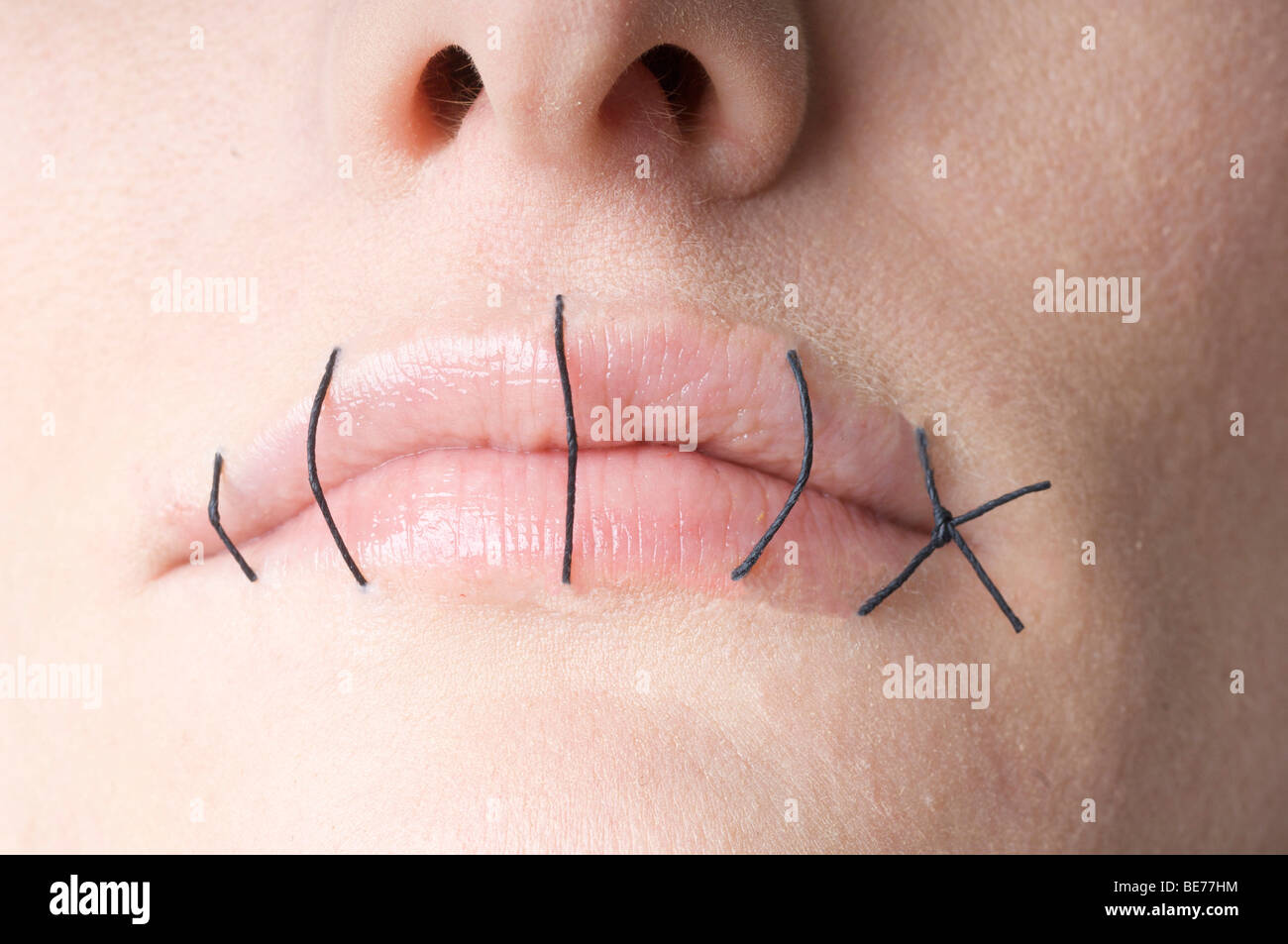 Mouth sewn together Stock Photo
