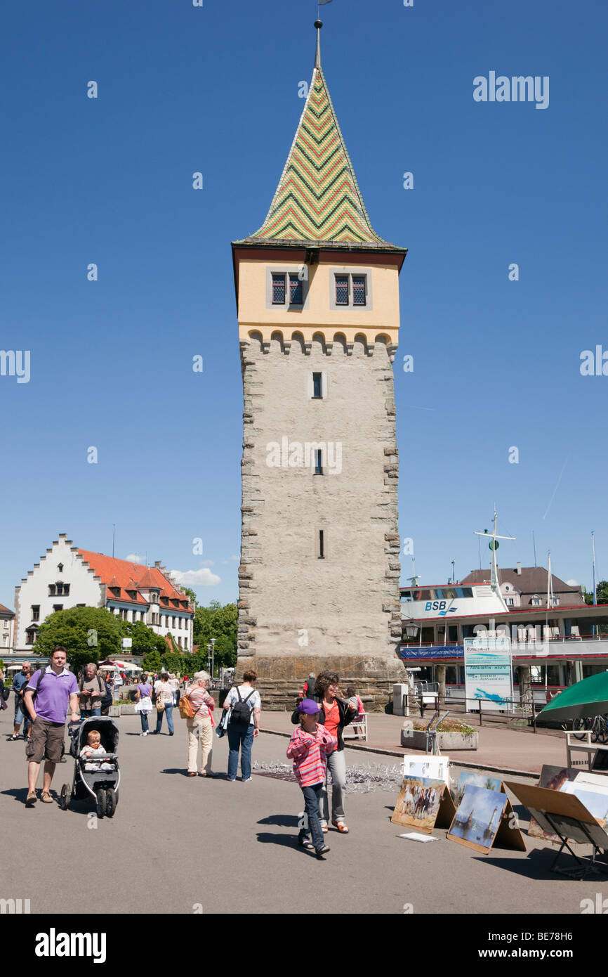 Mangturm and tourists on waterfront promenade in picturesque Old Town (Altstadt) on Lake Constance. Lindau, Bavaria, Germany Stock Photo