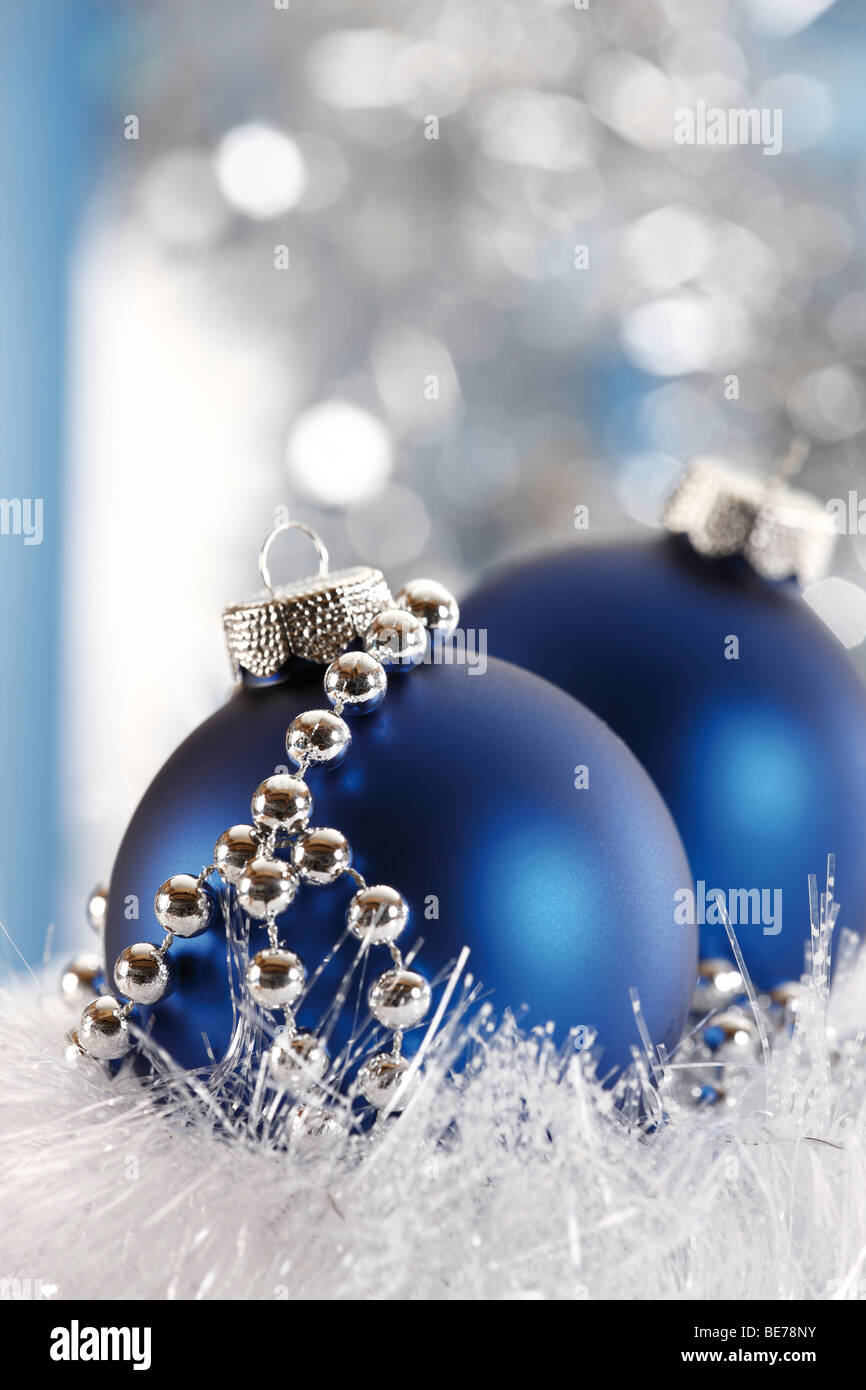 Blue Christmas balls with a pearl necklace, in white snow garland Stock Photo
