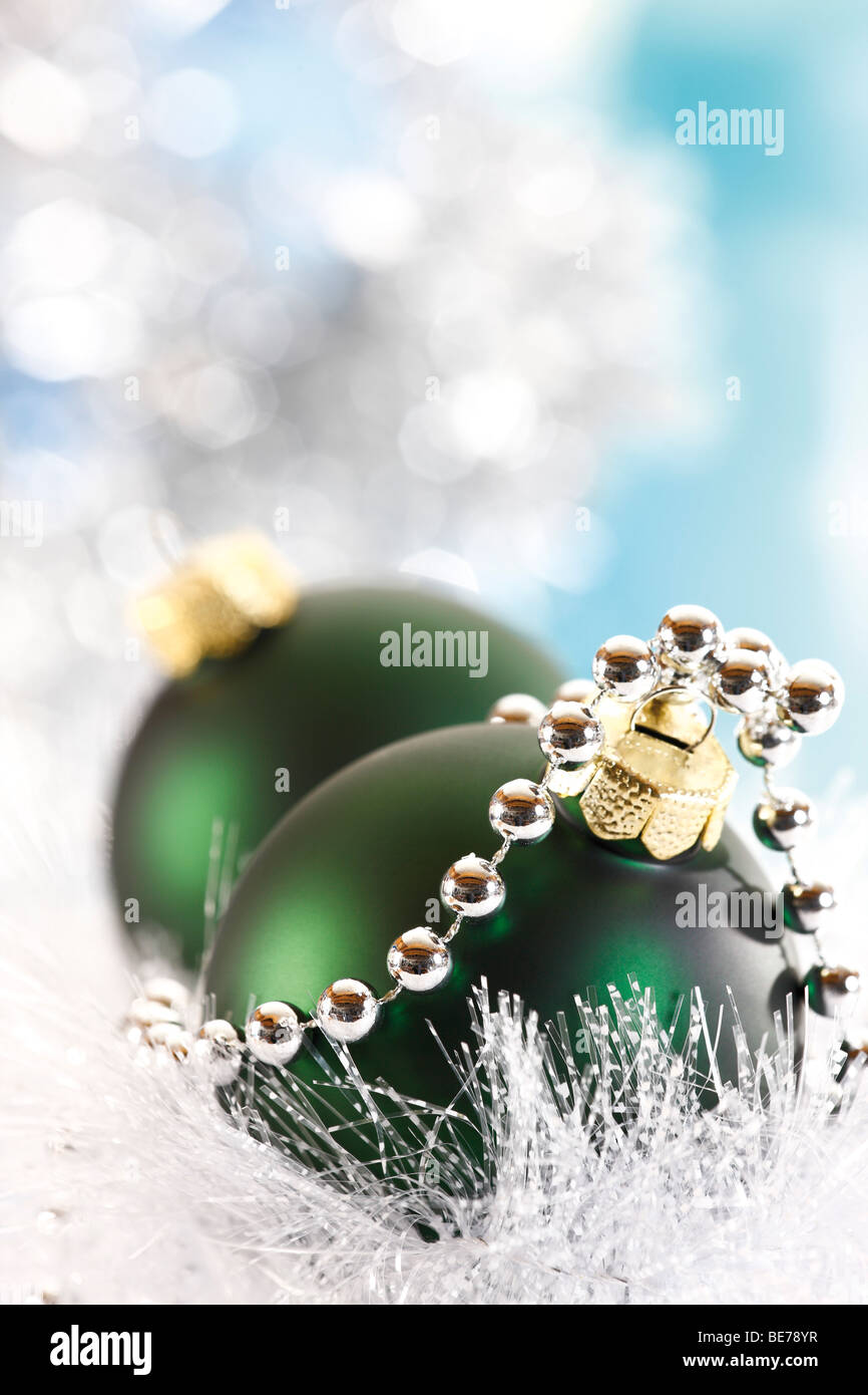 Green Christmas balls with a pearl necklace, in white snow garland Stock Photo