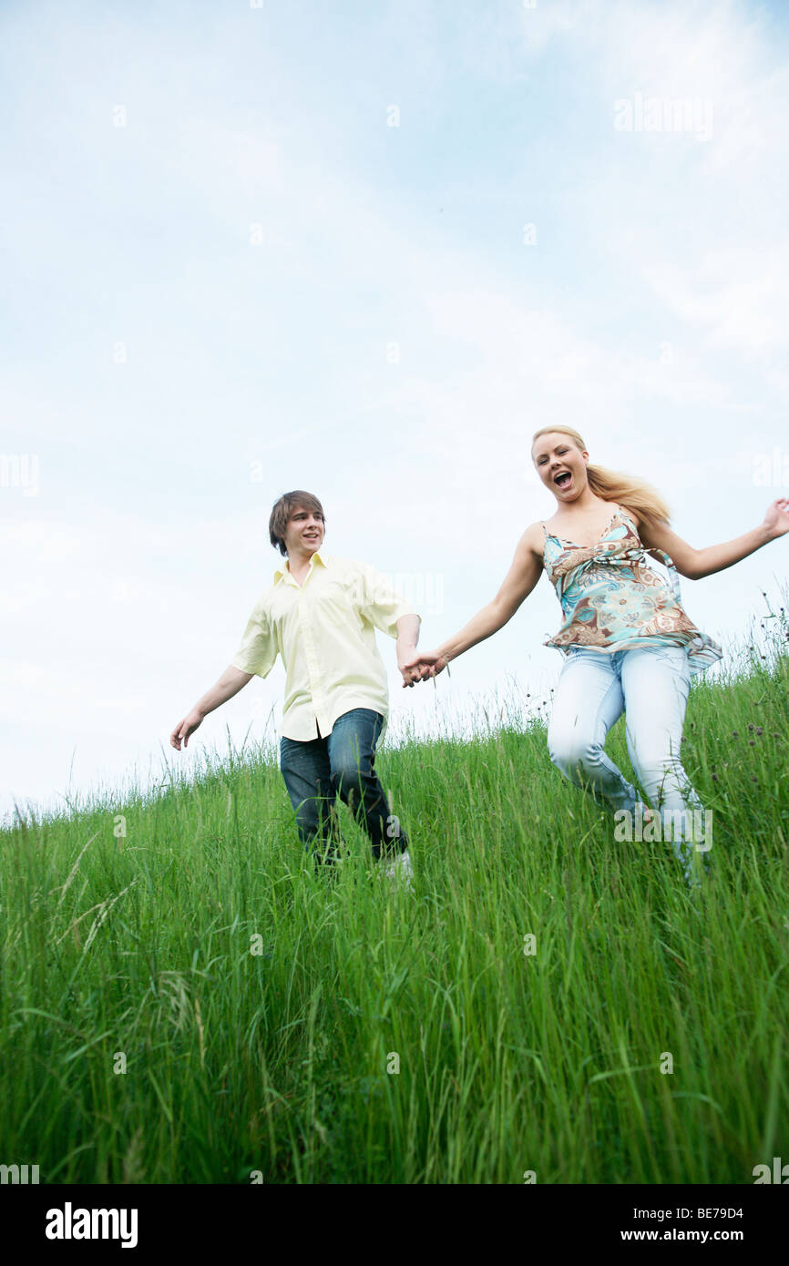 Woman younger man holding hands hi-res stock photography and images - Alamy