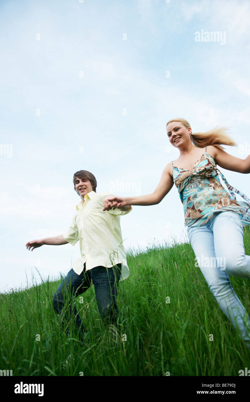 Woman younger man holding hands hi-res stock photography and images - Alamy